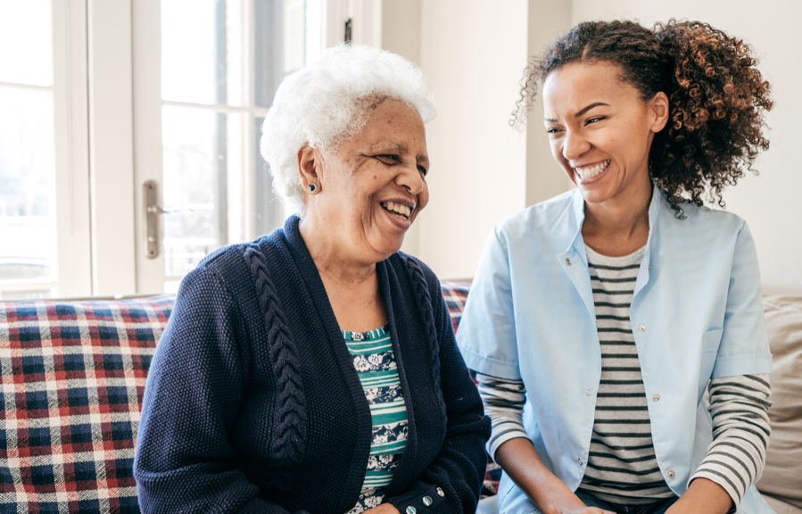 A young woman and an elderly woman laughing together | BCBS of Tennessee