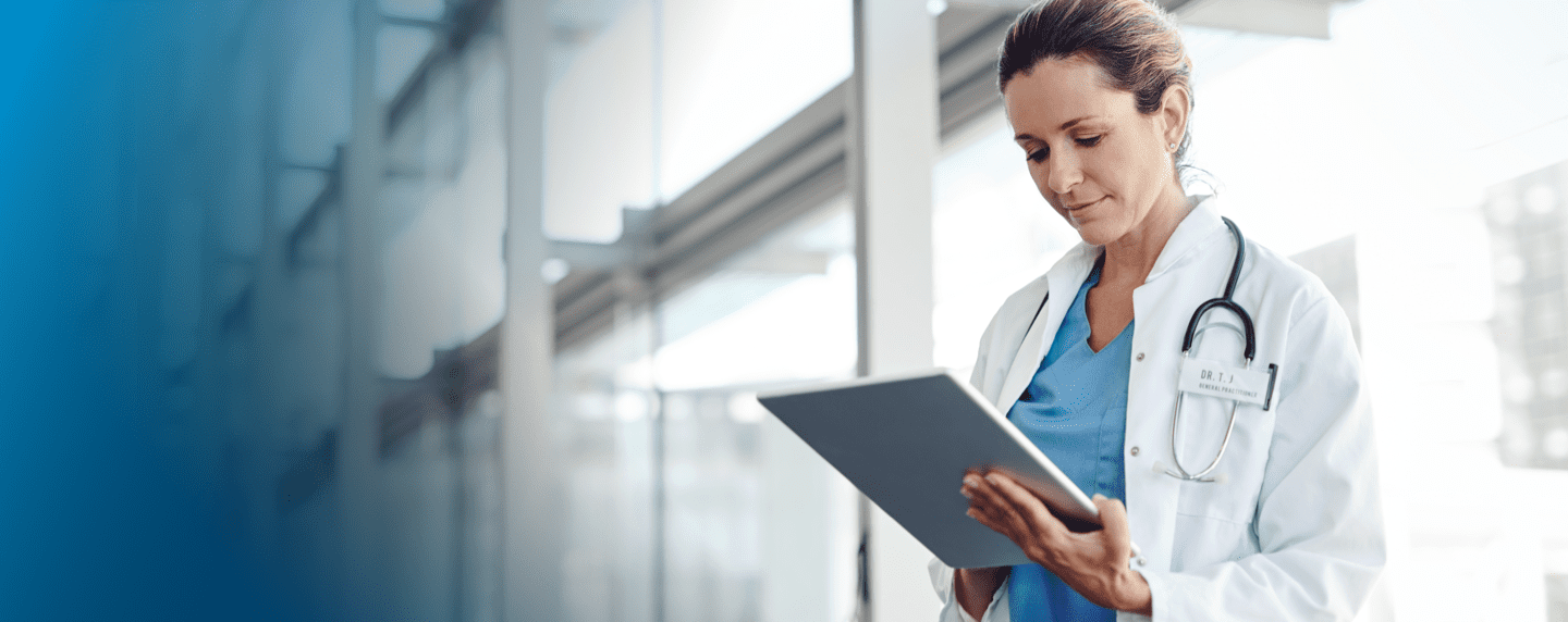 Female medical provider looking down at a tablet
