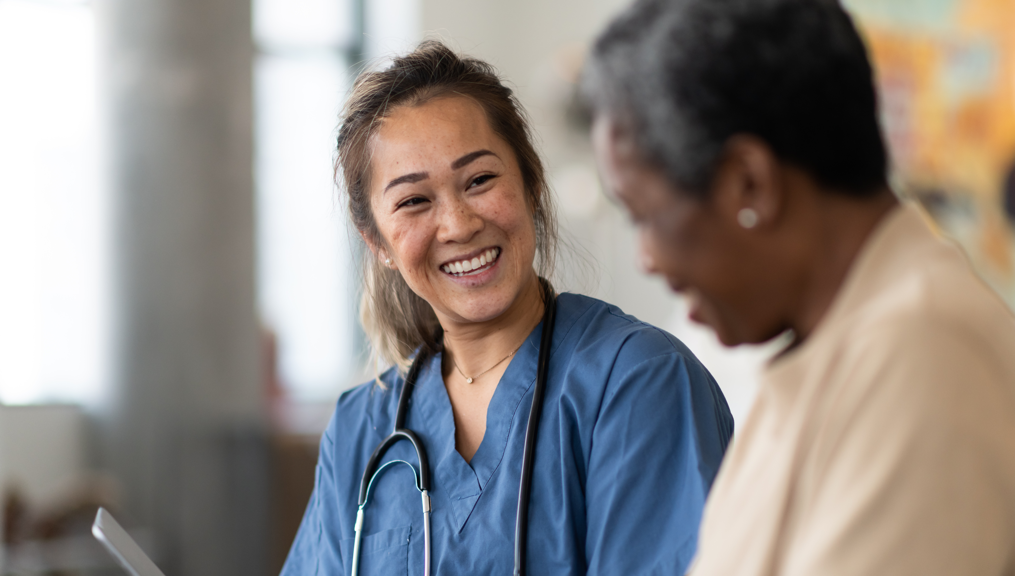 Female medical staff smiling at elderly patient | BCBS of Tennessee