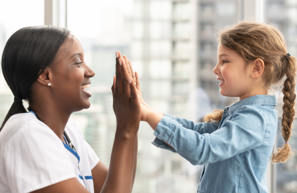 Child giving doctor high-five | BCBS of Tennessee