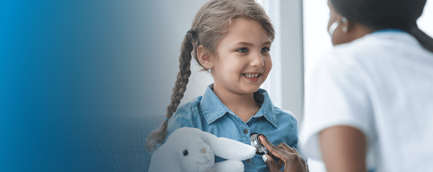 Little girl hold stuffed toy receiving checkup from provider | BCBS of Tennessee