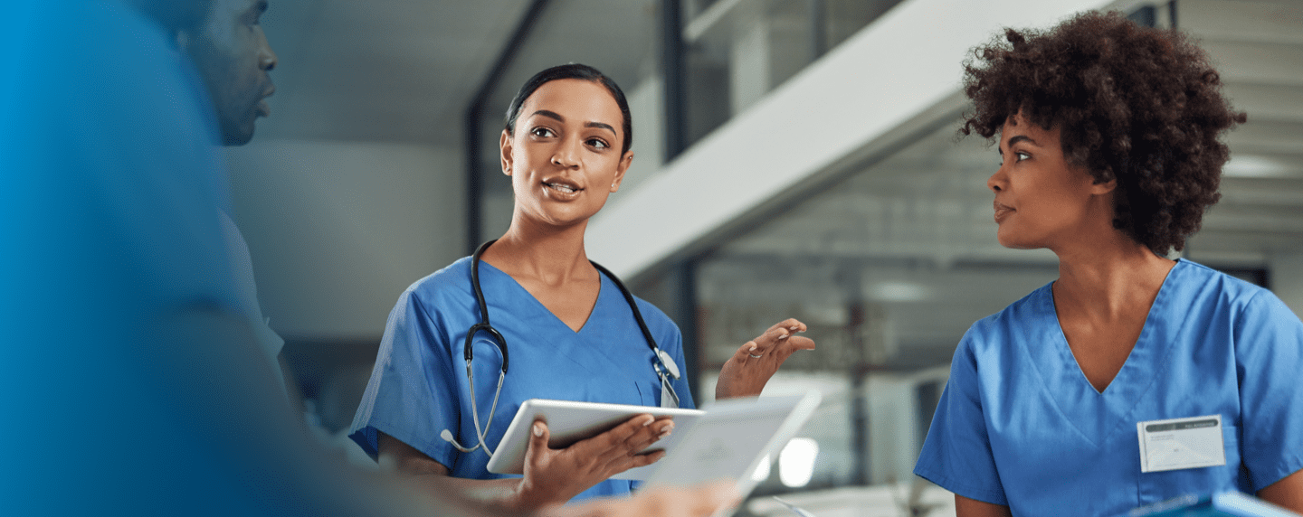 Female medical provider looking down at a tablet